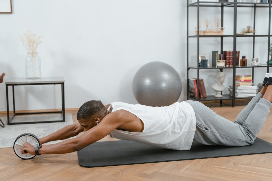 Man using an ab roller on a yoga mat indoors, promoting fitness and a healthy lifestyle.